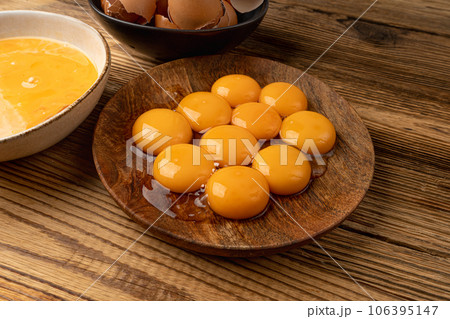 Egg Yolks in Bowl, Fresh Chicken Egg Yolk Separated from Whites for Cooking Recipe, Organic Yolks Top View 106395147