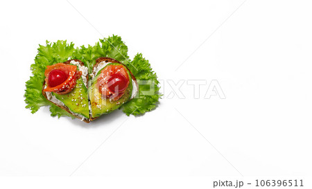 sandwich of heart shaped grain bread curd cheese, avocado salmon, lettuce, cherry tomatoes sesame on white background 106396511