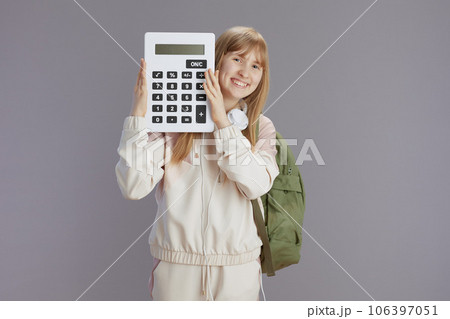 smiling trendy teen girl in beige tracksuit with backpack smiling trendy teen girl in beige tracksuit with backpack 106397051