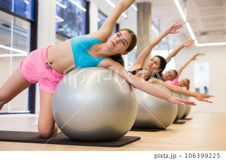 Young woman training pilates at group class 106399225