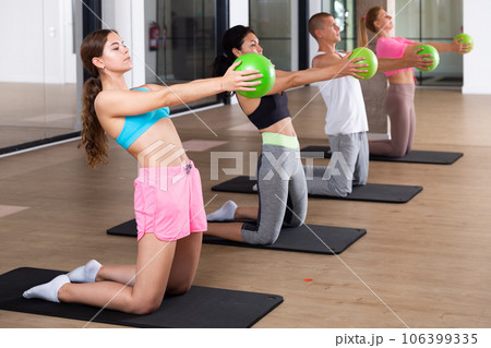 Four people doing exercises with bender balls Four people doing exercises with bender balls 106399335