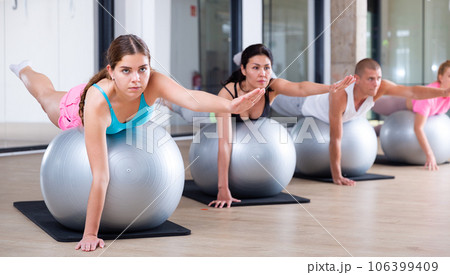 Four people lying in superman's pose 106399409