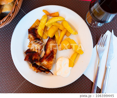 Delicious fried veal filet with freshly ground pepper served with french fries. 106399445