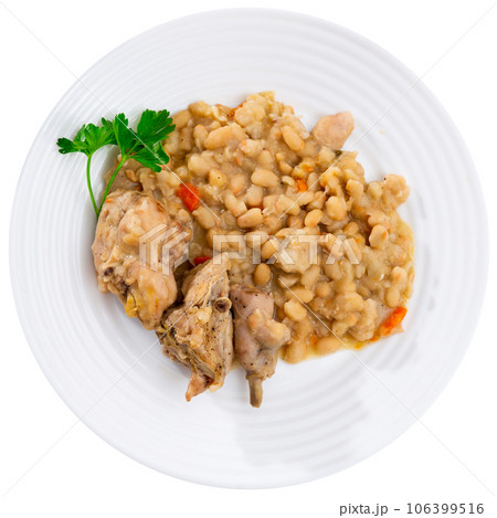 Oven-baked rabbit leg with braised beans in bowl, top view. Oven-baked rabbit leg with braised beans in bowl, top view. 106399516