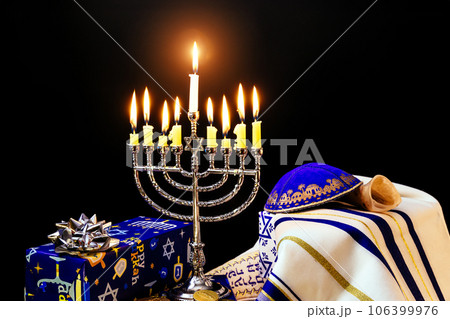 Festival of hanukkah menorah candles lighting up at jewish celebration Festival of hanukkah menorah candles lighting up at jewish celebration 106399976