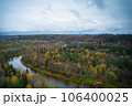 Above aerial shot of green pine forests and yellow foliage groves with beautiful texture of golden treetops. Beautiful fall season scenery in evening. Mountains in autumn colors in golden time 106400025