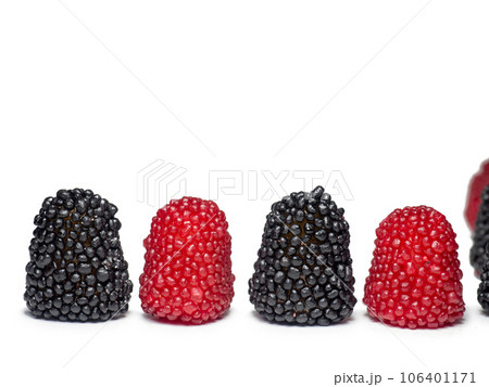 red and black gummies in the form of berries. Sweets in the form of raspberries and blackberries on a white background. Marmalade isolate. 106401171