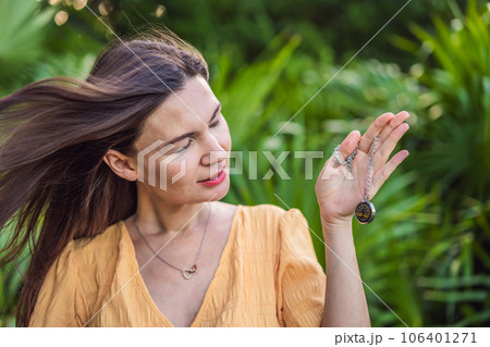 pregnant woman after 40 demonstrating the use of an aroma pendant, combining style and aromatherapy during her pregnancy journey pregnant woman after 40 demonstrating the use of an aroma pendant, combining style and aromatherapy during her pregnancy journey 106401271