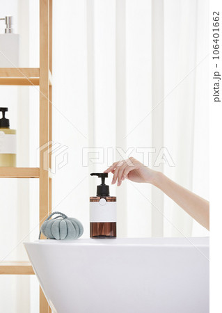 beauty concept photo of korean asain beautiful woman applying shower gel onto a shower pouf. beauty concept photo of korean asain beautiful woman applying shower gel onto a shower pouf. 106401662