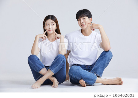 korean asian young couple sitting and touching their skin korean asian young couple sitting and touching their skin 106402003