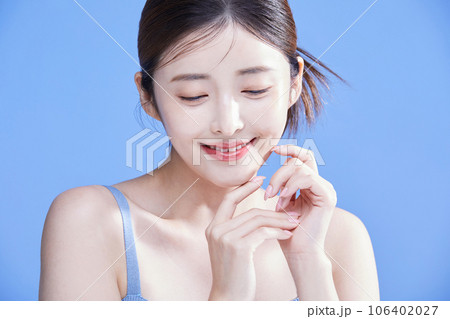 beauty concept photo of korean asain beautiful woman smiling with both hands clasped together 106402027