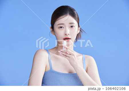 beauty concept photo of korean asain beautiful woman holding a lipbalm 106402106