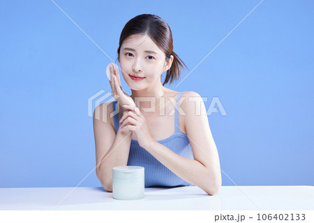 beauty concept photo of korean asain beautiful woman holding cleansing pads alongside a product 106402133