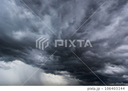 The dark sky with heavy clouds converging and a violent storm before the rain.Bad or moody weather sky and environment. carbon dioxide emissions, greenhouse effect, global warming, climate change 106403144