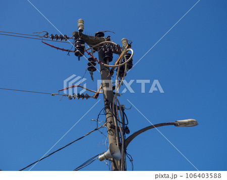 Electrification. A pole entangled with many wires. Power pole. Old technologies. Electrification. A pole entangled with many wires. Power pole. Old technologies. 106403588