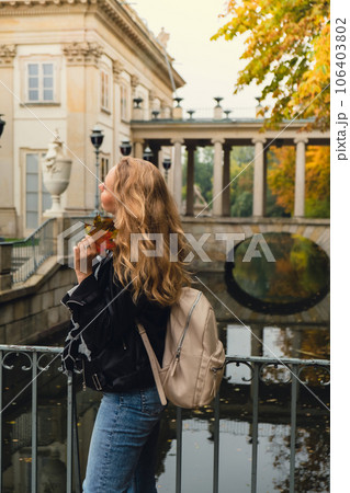 Tourist attraction woman travel enjoying nature sightseeing Baths classicist Palace on the Isle in Lazienki Park touristic place in Warsaw. Lazienki Royal Baths Park, Baroque columns Warsaw Poland Tourist attraction woman travel enjoying nature sightseeing Baths classicist Palace on the Isle in Lazienki Park touristic place in Warsaw. Lazienki Royal Baths Park, Baroque columns Warsaw Poland 106403802