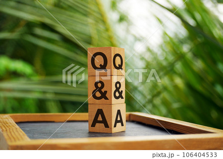 Q and A - stands for wooden blocks with letters on bokeh nature background with sunlight. 106404533