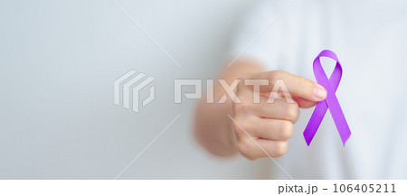 Woman holding purple Ribbon for Violence, Pancreatic, Esophageal, Testicular cancer, Alzheimer, epilepsy, lupus, Sarcoidosis and Fibromyalgia. Awareness month and World cancer day concept 106405211