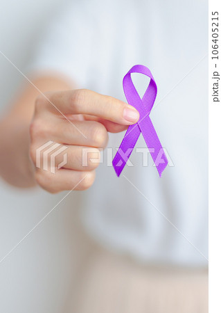 Woman holding purple Ribbon for Violence, Pancreatic, Esophageal, Testicular cancer, Alzheimer, epilepsy, lupus, Sarcoidosis and Fibromyalgia. Awareness month and World cancer day concept 106405215