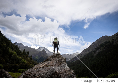 Hiking woman in high altitude mountains Hiking woman in high altitude mountains 106406209
