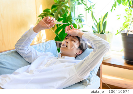風邪の男性、熱がある男性と体温計 106410674