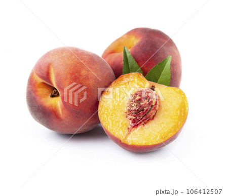 Sweet peaches with leaves on white backgrounds Sweet peaches with leaves on white backgrounds 106412507