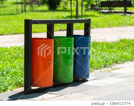 Colorful metal recycle trash bins for paper, glass, plastic and general waste public park urban area Garbage sorting 106412774