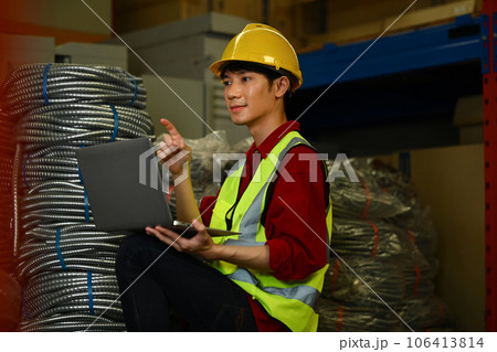 Asian man warehouse worker in reflective jackets using digital tablet, checking stock and order details in warehouse Asian man warehouse worker in reflective jackets using digital tablet, checking stock and order details in warehouse 106413814