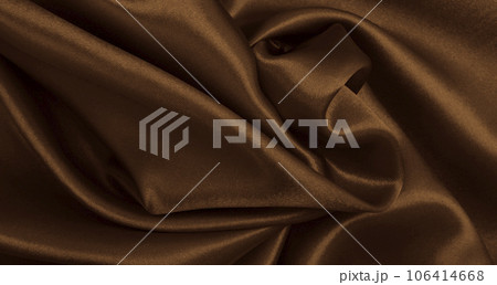 Smooth elegant brown silk or satin luxury cloth texture as abstract background. Luxurious background design wallpaper. In Sepia toned. Retro style 106414668