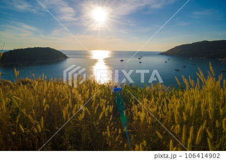 Sunset on Phuket island viewpoint turquoise sea water with yellow grass 106414902