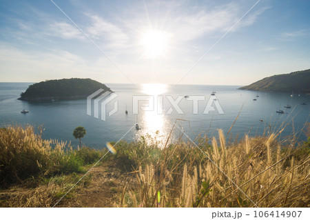 Sunset on Phuket island viewpoint turquoise sea water with yellow grass 106414907