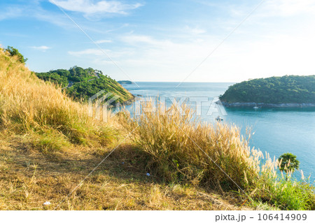 Sunset on Phuket island viewpoint turquoise sea water with yellow grass 106414909