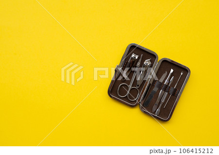 Manicure set on a yellow background close-up 106415212