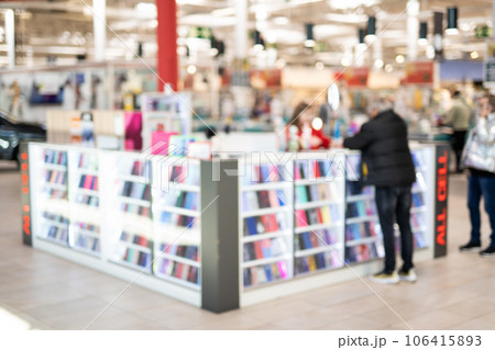 Blurred photo of a stand with phone cases in a supermarket. 106415893