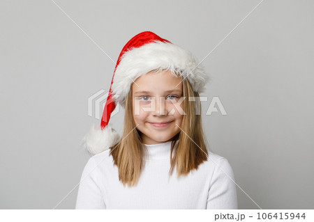 Christmas portrait of pretty adorable child girl in Santa hat on white background 106415944