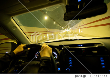 People driving car in tunnel 106416633