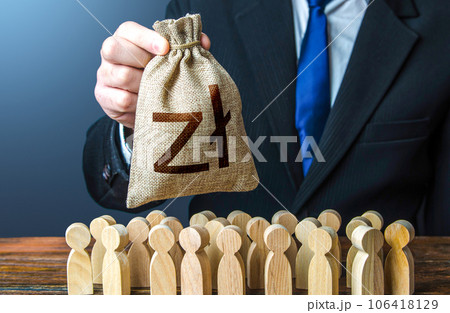 Businessman holds out a polish zloty money bag to the crowd. Compensation payments. Providing money, paying salaries and grants. Financial support. Tax collection. Staff maintenance. Businessman holds out a polish zloty money bag to the crowd. Compensation payments. Providing money, paying salaries and grants. Financial support. Tax collection. Staff maintenance. 106418129
