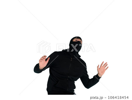 Thief with balaclava acts in silence to steal apartments with wire cutters in hand Thief with balaclava acts in silence to steal apartments with wire cutters in hand 106418454