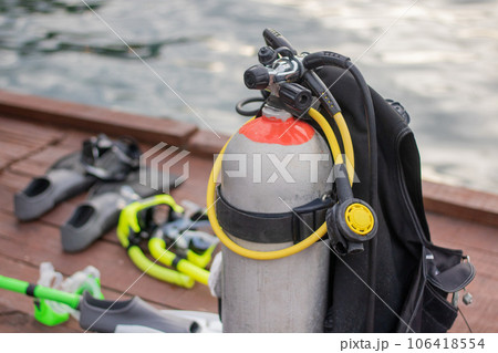 Full set of Scuba Diving equipment with selective focus on wooden pier. Full set of Scuba Diving equipment with selective focus on wooden pier. 106418554