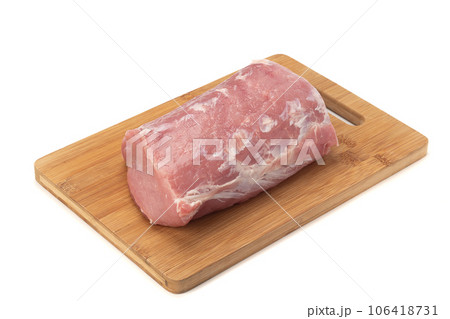 Fresh piece of raw pork meat on wooden cutting board over white background. Fresh piece of raw pork meat on wooden cutting board over white background. 106418731