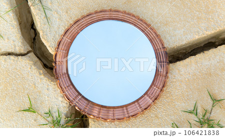 Round mirror on dry desert land, reflection of the sky in the mirror Round mirror on dry desert land, reflection of the sky in the mirror 106421838