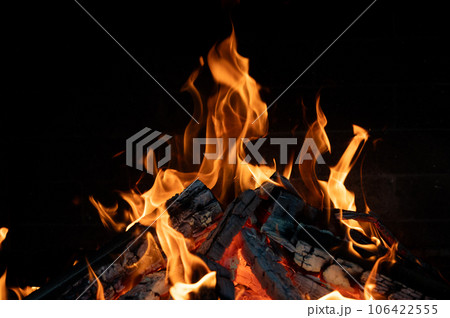 Close-up of a fire burning in a fireplace. Close-up of a fire burning in a fireplace. 106422555