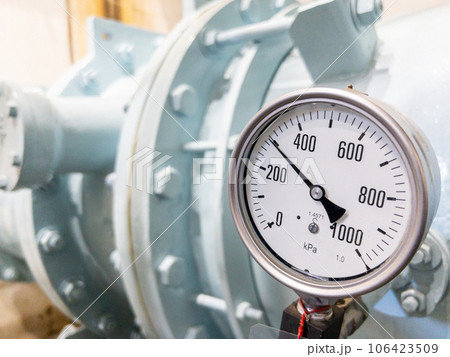 Closeup of the large dial gauge on the water pipe. Closeup of the large dial gauge on the water pipe. 106423509