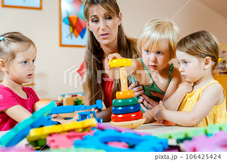 Children in nursery school learning and playing 106425424