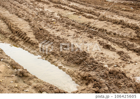 Mud and puddle on a sandy road Mud and puddle on a sandy road 106425605