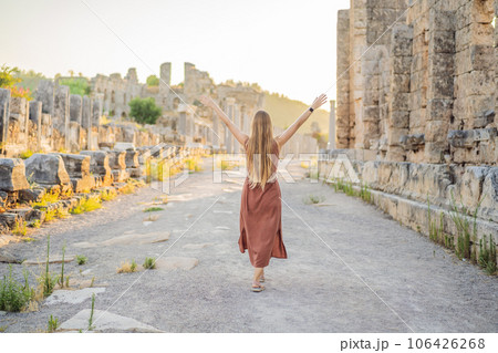Pretty tourist woman at the ruins of ancient city of Perge near Antalya Turkey 106426268