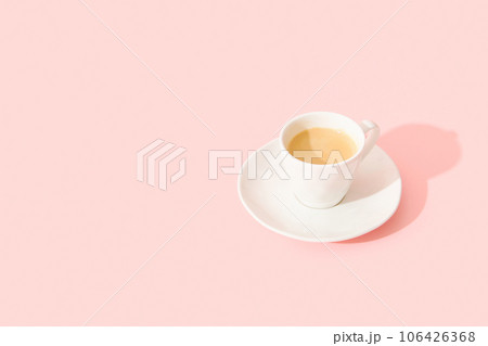 Espresso coffee on pastel pink background with long shadow 106426368