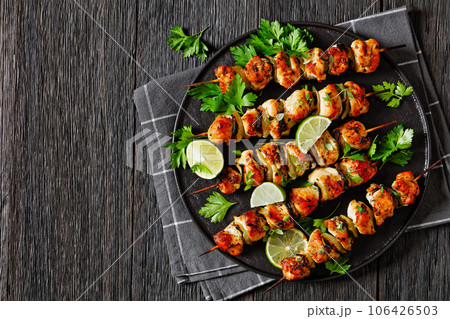 chicken souvlaki with parsley and lime on plate 106426503