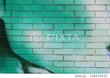 green painted brick wall , graffiti background green painted brick wall , graffiti background 106426610