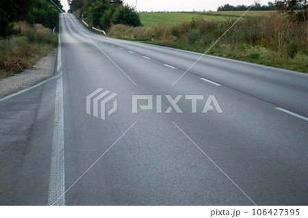 empty asphalt road at sunset 106427395